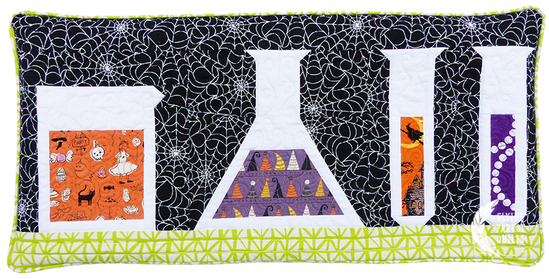 Potions Halloween pillow by Sylvia Schaefer | Flying Parrot Quilts | www.flyingparrotquilts.com