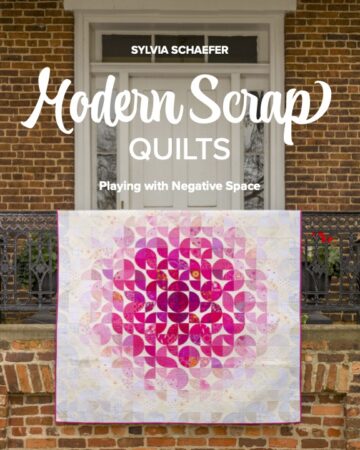 11606_FT_Cover A book cover featuring a pink and white quilt draped over a railing. The title is "Modern Scrap Quilts: Playing with Negative Space" by Sylvia Schaefer
